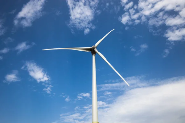 Wind power turbine close up view over blue sky — Stock Photo, Image