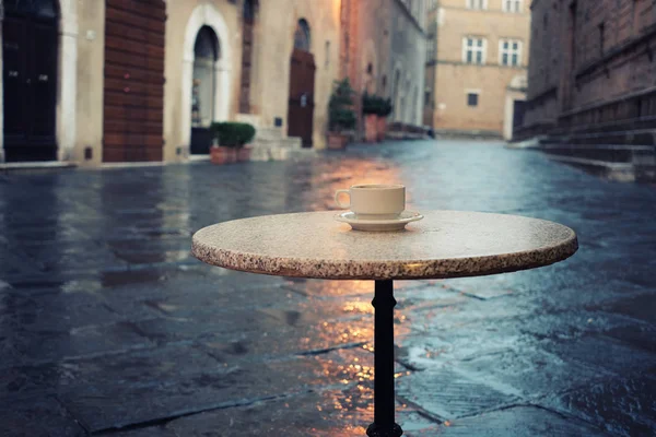 Cup of coffee on the old european city street cafe table — Stock Photo, Image