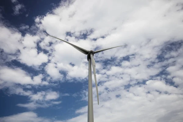 Wind power turbine close up view over blue sky — Stock Photo, Image