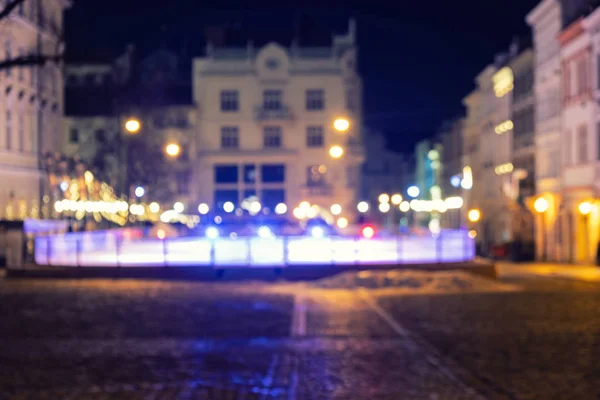 A crowd of people moving on the old european city night street defocused blurred abstract image — Stock Photo, Image