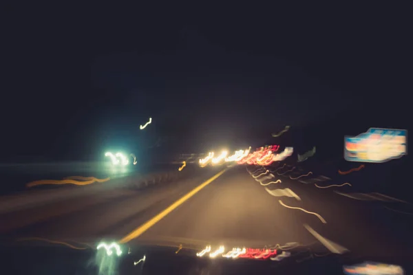 Fast night driving on highway, view from inside of a car