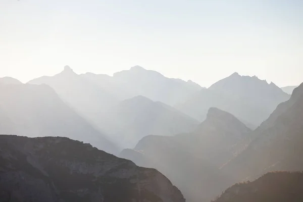 Mountain silhouettes at sunset. Alpine mountain panorama