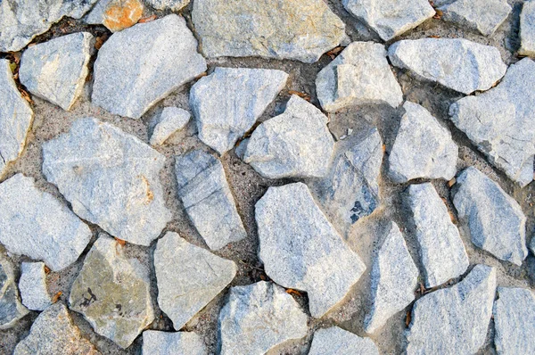 Het patroon van grote grijze scherpe stenen. De achtergrond — Stockfoto