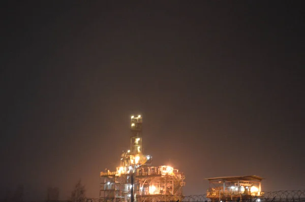 Nocne Zdjęcie Rafinerii Ropy Naftowej Roślina Przez Płot Drutu Kolczastego — Zdjęcie stockowe