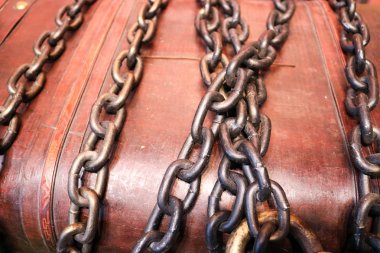 Bir büyük, güçlü, dayanıklı, kahverengi, ahşap sandık hazineleri ile bağlı, kalın demir cheins ile bağlı.