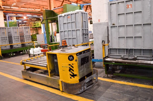 Self-propelled, self-contained yellow metal trolley, a machine for the transport of goods traveling through magnetic strips, paths in the production shop of a petrochemical, oil refinery