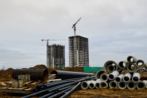 Construction of large modern monolithic frame houses, buildings using industrial construction equipment and large high cranes. Construction of the building in the new micro district of the city