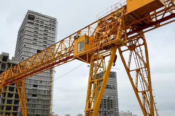 高重い黄色金属鉄耐荷重構造建物や家の近代的な建設現場で貨物を持ち上げるためのサポート上のブリッジタイプの固定工業用強力なガントリークレーン — ストック写真