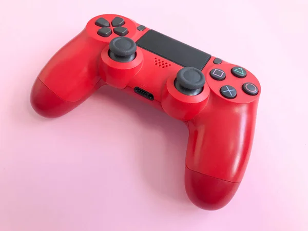 Beautiful red digital modern new game joystick for computer video games gamepad on a pink background — Stock Photo, Image