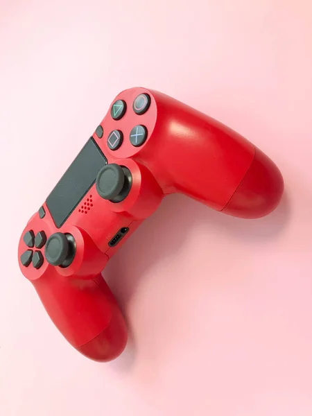 Beautiful red digital modern new game joystick for computer video games gamepad on a pink background — Stock Photo, Image