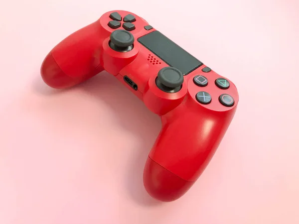 Beautiful red digital modern new game joystick for computer video games gamepad on a pink background — Stock Photo, Image