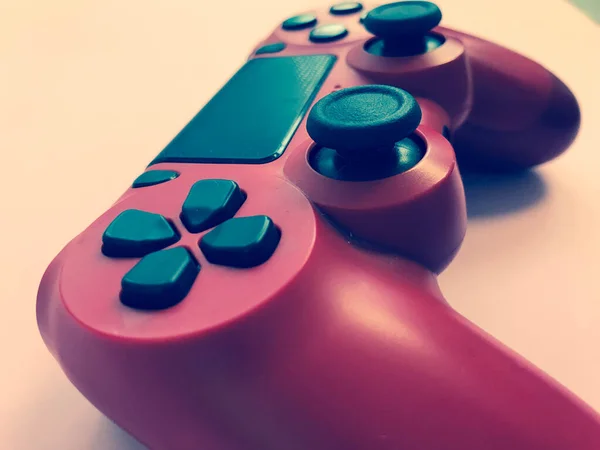 Beautiful red digital modern new game joystick for computer video games gamepad on a pink background — Stock Photo, Image