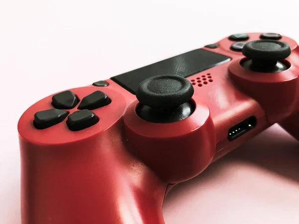 Beautiful red digital modern new game joystick for computer video games gamepad on a pink background — Stock Photo, Image