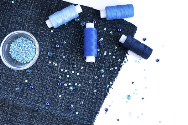 A set of materials for needlework in blue color