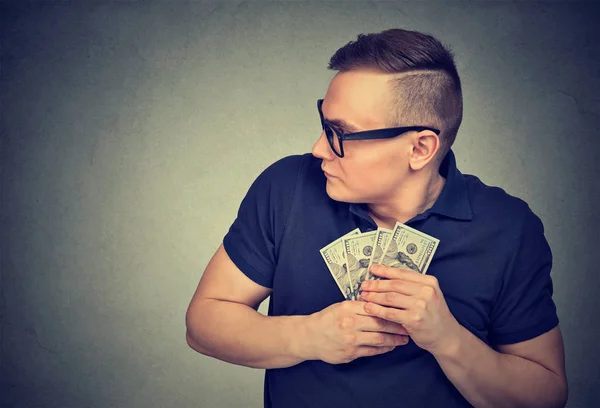 Suspicious greedy man grabbing money — Stock Photo, Image