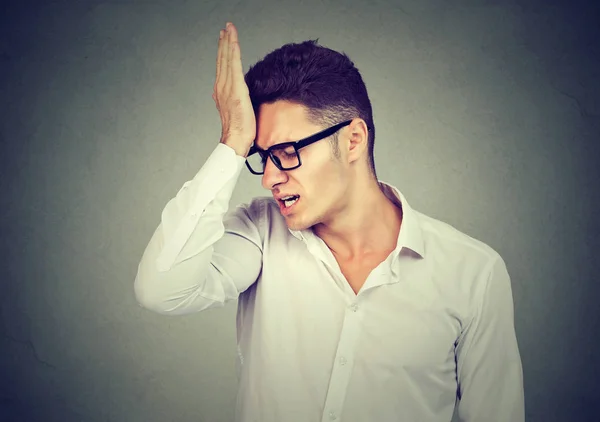 Man, slapping hand on head having regrets — Stock Photo, Image