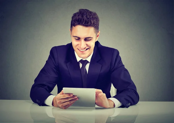 Lachende jonge zakenman met behulp van een tablet-pc — Stockfoto