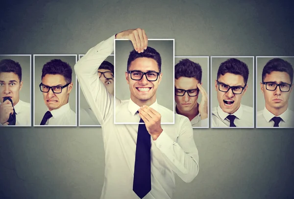 Masked young man in glasses expressing different emotions — Stock Photo, Image