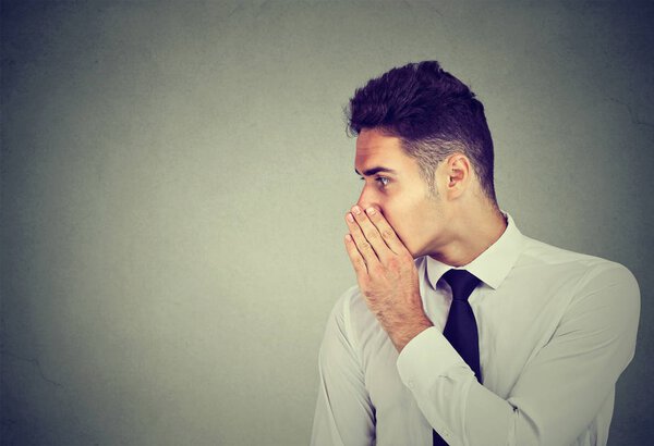 Business man whispering a gossip secret to someone