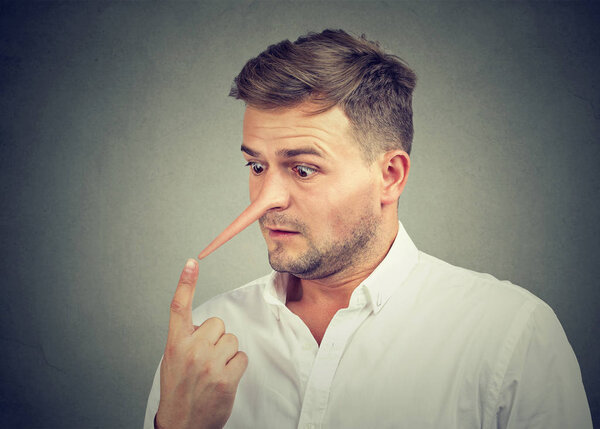 Worried shocked man with long nose. Liar concept.