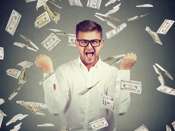 Excited man in flying money bills — Stock Photo, Image