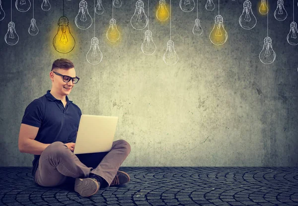 Intelligent young man with laptop