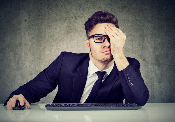 Tired business man at workplace