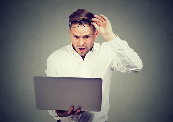 Shocked man happy with news on laptop — Stok Foto