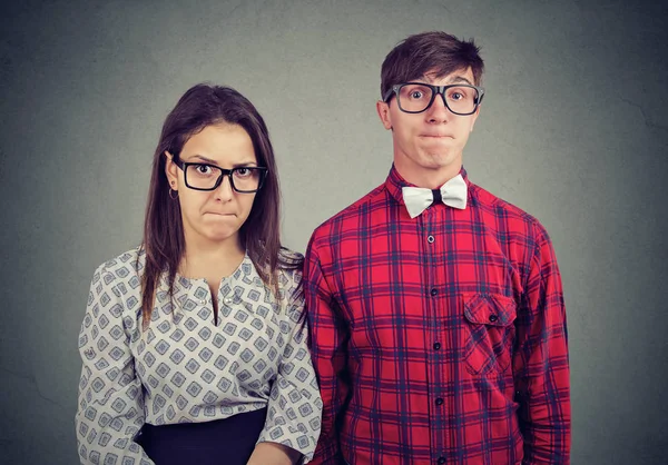 Couple standing next to each other pressing their lips with displeasure having bad mood — Stock Photo, Image