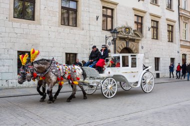 Krakow, Polonya - 21 Nisan 2017: Atlar atlı arabaları Krakow eski şehirde. Krakow ikinci büyük ve Polonya'nın en eski şehirlerinden biridir.