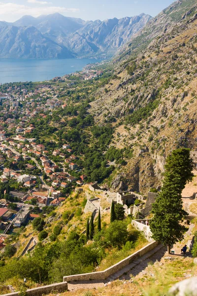 Looking over the Bay of Kotor in Montenegro with view of mountains, boats and old houses with red tile roofs — Stock Photo, Image