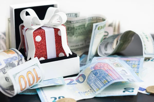 Red toy gift and euro on black — Stock Photo, Image