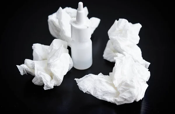 stock image Nasal spray, nasal drops and crumpled handkerchief on table. Focus on handkerchief