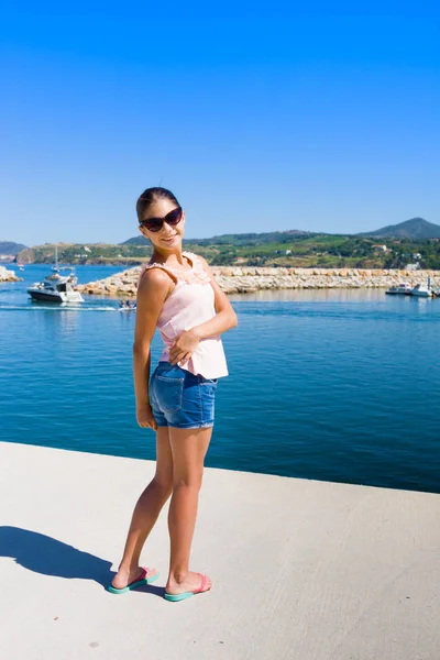 Smiling girl against sea port in Argeles sur mer. France — Stock Photo, Image