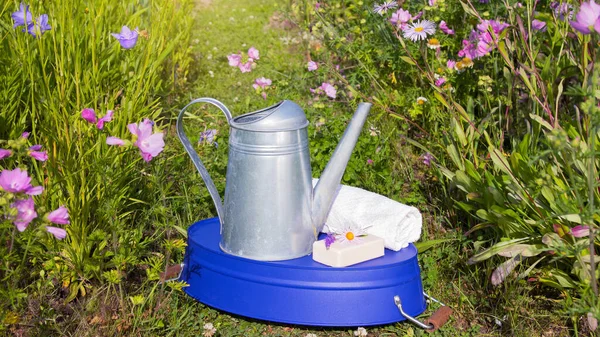 Metal Watering Can Purple Basin Toilet Soap White Towel Flowers — Stock Photo, Image
