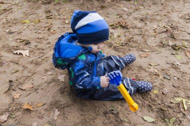 sonbaharda kumda oynayan bebek