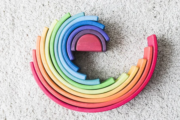 Wooden waldorf rainbow on white carpet — Stock Photo, Image