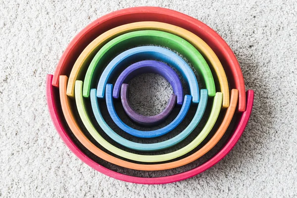 Wooden waldorf rainbow on white carpet — Stock Photo, Image