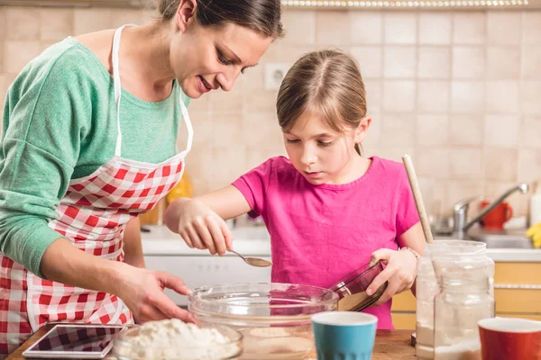 Daughter and mother making dough Royalty Free Stock Images