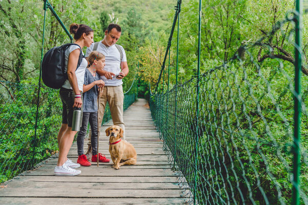 Family with dog in forest