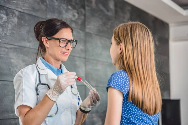 Pediatra femenina usando hisopo —  Fotos de Stock