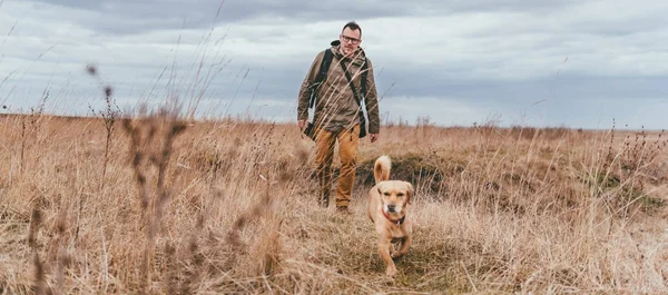 Hiker and small yellow dog — Stock Photo, Image