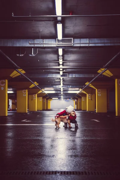 Girl with dog in public garage — Stock Photo, Image