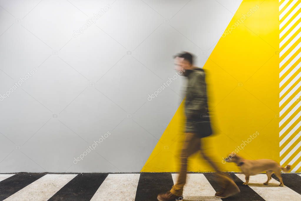Man with small yellow dog 
