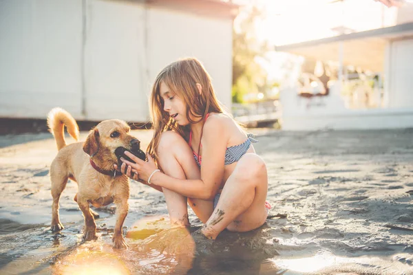 Girl with small yellow dog — Stock Photo, Image
