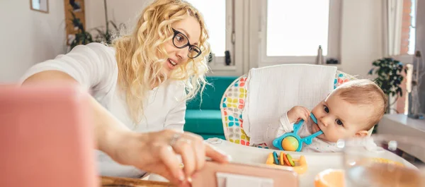 Mother Showing Baby Entertaining Video Smart Phone While She Working — Stock Photo, Image