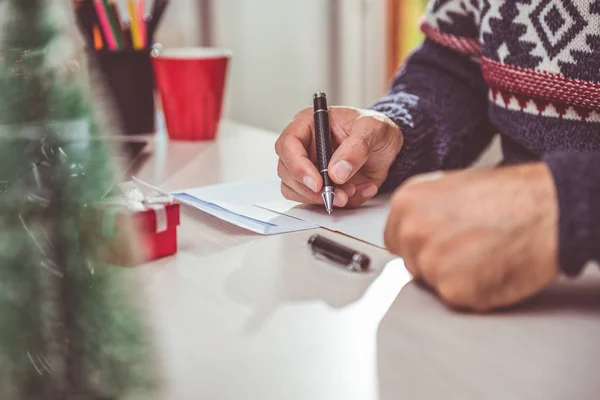 man writing christmas letter