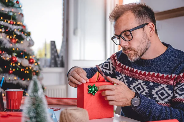 Man wrapping Christmas gift — Stock Photo, Image