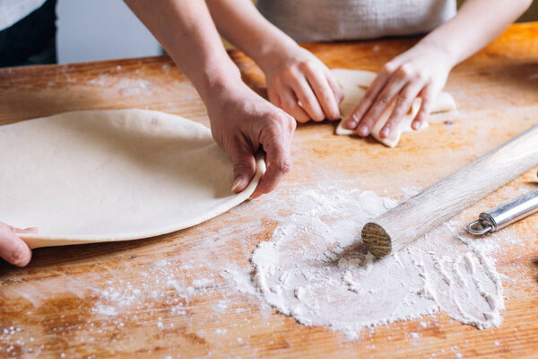 close-up of Mother and daughter making dough