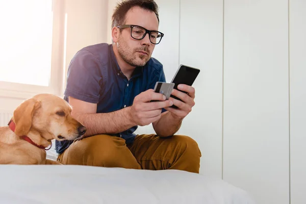 Man Glasses Blue Shirt Sitting Bed Using Smart Phone Pay — Stock Photo, Image